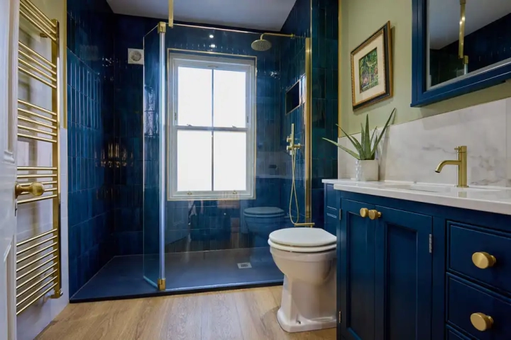Bathroom With Deep Blue Cupboards and Tiles