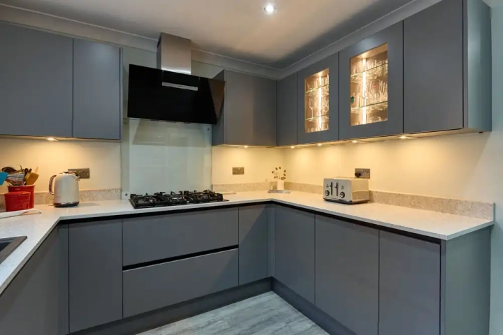 Grey Kitchen with White Counters and Under Cabinet Lighting